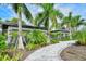 Paver path leading to a covered pavilion with lush landscaping and a serene ambiance at 12708 Aquamarine Ave, Bradenton, FL 34211