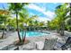 Enjoy the community pool with ample seating and lush landscaping under clear skies at 12708 Aquamarine Ave, Bradenton, FL 34211
