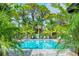 Resort-style pool area with palm trees and comfortable lounge seating provides a relaxing escape at 12708 Aquamarine Ave, Bradenton, FL 34211
