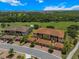 Stunning aerial view of the condos nestled in a lush, green landscape next to a golf course with verdant trees at 13810 Messina Loop # 202, Bradenton, FL 34211