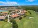 Aerial view of homes on a golf course with lush landscaping and community lake at 13810 Messina Loop # 202, Bradenton, FL 34211