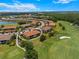 Aerial view of a home surrounded by a golf course with lush landscaping and lake at 13810 Messina Loop # 202, Bradenton, FL 34211