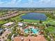 Overhead view of community pool, lake, and golf course in a vibrant setting at 13810 Messina Loop # 202, Bradenton, FL 34211
