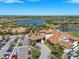 Aerial view of community with lake, pools, clubhouse, and lush landscaping at 13810 Messina Loop # 202, Bradenton, FL 34211