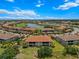 Aerial view of the community and lake, surrounded by lush trees at 13810 Messina Loop # 202, Bradenton, FL 34211
