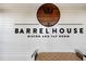 Close-up of the Barrel House Bistro and Tap Room sign on a shiplap wall with a wooden logo at 13810 Messina Loop # 202, Bradenton, FL 34211