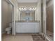 Elegant bathroom featuring double sinks, granite countertops, and a walk-in shower with neutral tile at 13810 Messina Loop # 202, Bradenton, FL 34211