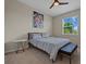 Comfortable bedroom with large window, modern art and bench at the end of the bed at 13810 Messina Loop # 202, Bradenton, FL 34211