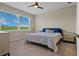 Cozy bedroom featuring a large window and a comfortable king-sized bed with stylish linens at 13810 Messina Loop # 202, Bradenton, FL 34211