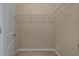 Walk-in closet with carpeted floors and metal shelving for organized storage at 13810 Messina Loop # 202, Bradenton, FL 34211