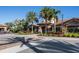 Beautiful clubhouse exterior with tile roof, stone accents, and colorful landscaping at 13810 Messina Loop # 202, Bradenton, FL 34211