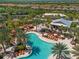 Overhead view of the beautiful pool area with palm trees and cozy seating at 13810 Messina Loop # 202, Bradenton, FL 34211