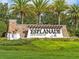 Esplanade Golf & Country Club stone sign with palm trees and green shrubbery at 13810 Messina Loop # 202, Bradenton, FL 34211