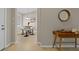 Bright dining area featuring a modern round table with chairs, illuminated by a chandelier, next to the entryway at 13810 Messina Loop # 202, Bradenton, FL 34211