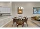 Bright dining area features a glass table, modern chairs, and stylish light fixture at 13810 Messina Loop # 202, Bradenton, FL 34211