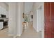 Inviting entryway with stylish console table, leading to the living area and modern kitchen with stainless steel appliances at 13810 Messina Loop # 202, Bradenton, FL 34211