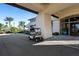 Clubhouse entrance with a golf cart parked nearby, showcasing modern architecture and landscaping at 13810 Messina Loop # 202, Bradenton, FL 34211