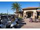 Golf carts parked near a clubhouse with stone accents and manicured landscaping at 13810 Messina Loop # 202, Bradenton, FL 34211