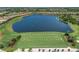 Aerial view of a lake and golf course with lush green fairways at 13810 Messina Loop # 202, Bradenton, FL 34211