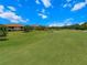 View of the lush green golf course, trees and sand traps surrounding homes at 13810 Messina Loop # 202, Bradenton, FL 34211