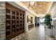 A hallway featuring brick ceilings, patterned tile floors, and wine storage at 13810 Messina Loop # 202, Bradenton, FL 34211