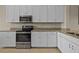 Bright white kitchen with granite counters, stainless steel appliances, and tiled flooring at 13810 Messina Loop # 202, Bradenton, FL 34211