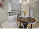 Bright kitchen and breakfast nook with a round wood table and modern white cabinetry and granite countertops at 13810 Messina Loop # 202, Bradenton, FL 34211