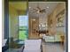 Bright, open-concept living room with a view of the outdoor patio and modern decor at 13810 Messina Loop # 202, Bradenton, FL 34211