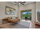 Comfortable living room featuring sliding glass doors leading to outdoor balcony with ceiling fan at 13810 Messina Loop # 202, Bradenton, FL 34211