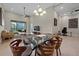 Spacious living room with high ceilings, lots of natural light, and glass table with six chairs at 13810 Messina Loop # 202, Bradenton, FL 34211