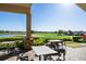 An outdoor patio with a view of the golf course on a sunny day at 13810 Messina Loop # 202, Bradenton, FL 34211
