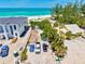 Beachfront property featuring both new and older construction with parking and palm trees at 145 50Th St, Holmes Beach, FL 34217