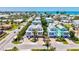 Aerial view of colorful coastal homes with palm trees, neat landscaping, and a glimpse of the ocean in the distance at 145 50Th St, Holmes Beach, FL 34217