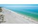 Expansive view of a pristine beach with clear, turquoise water stretching to the horizon at 145 50Th St, Holmes Beach, FL 34217