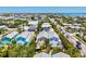Aerial view of several homes with the ocean in the distance, showcasing rooftops and neighborhood layout at 145 50Th St, Holmes Beach, FL 34217