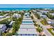 Aerial shot showing several homes with pools and tropical landscaping, with a view of the ocean in the background at 145 50Th St, Holmes Beach, FL 34217