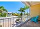 Relaxing balcony with tropical views and Adirondack chairs, perfect for enjoying the outdoors at 145 50Th St, Holmes Beach, FL 34217