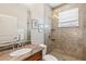 Bathroom with granite countertop, neutral tile and large glass enclosed shower at 145 50Th St, Holmes Beach, FL 34217