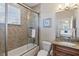 Cozy bathroom with granite countertop, neutral tile and glass enclosed bathtub/shower combo at 145 50Th St, Holmes Beach, FL 34217
