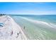 Stunning aerial shot of a pristine beach with crystal-clear waters and a vibrant shoreline at 145 50Th St, Holmes Beach, FL 34217