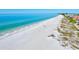 Expansive shoreline with clear blue water and white sand, ideal for a relaxing day by the sea at 145 50Th St, Holmes Beach, FL 34217