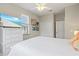 Bright bedroom with a ceiling fan, large window, wood floors and flatscreen TV at 145 50Th St, Holmes Beach, FL 34217