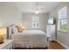 Bright bedroom with a ceiling fan, wood floors, large window, and flatscreen TV at 145 50Th St, Holmes Beach, FL 34217