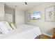 Comfortable bedroom with light walls, wood floor, ceiling fan and flatscreen TV at 145 50Th St, Holmes Beach, FL 34217