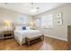 Bedroom with a king bed, hardwood floors, and natural light from the windows at 145 50Th St, Holmes Beach, FL 34217
