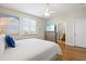 Bedroom features a TV, hardwood floors, natural light, and access to the bathroom at 145 50Th St, Holmes Beach, FL 34217