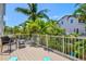 A spacious deck with seating offers views of lush tropical foliage and a neighboring home at 145 50Th St, Holmes Beach, FL 34217