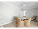 Bright dining room with glass table, woven chairs and view of hall at 145 50Th St, Holmes Beach, FL 34217