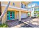 The blue door and tropical landscaping welcome you to this charming coastal home at 145 50Th St, Holmes Beach, FL 34217