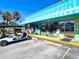 Retail storefront featuring a bright blue awning and inviting display window, golf carts parked nearby at 145 50Th St, Holmes Beach, FL 34217